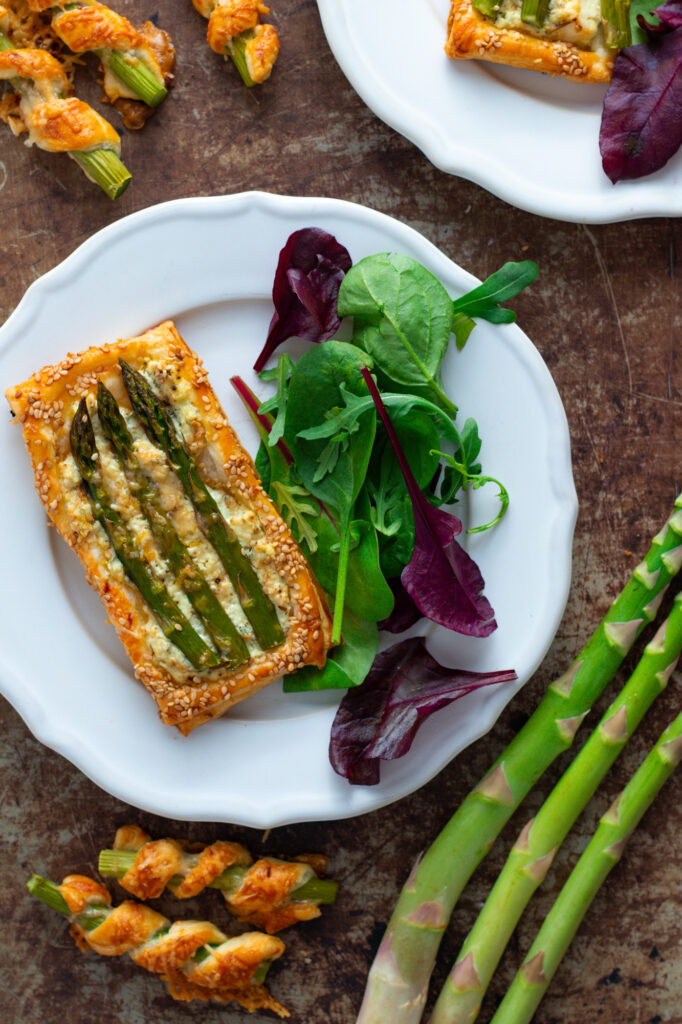 Asparagus and Goat Cheese Tart on a plate with salad.