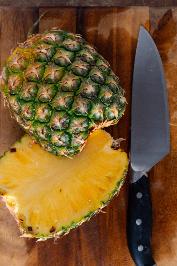 Fresh pineapple on a cutting board.