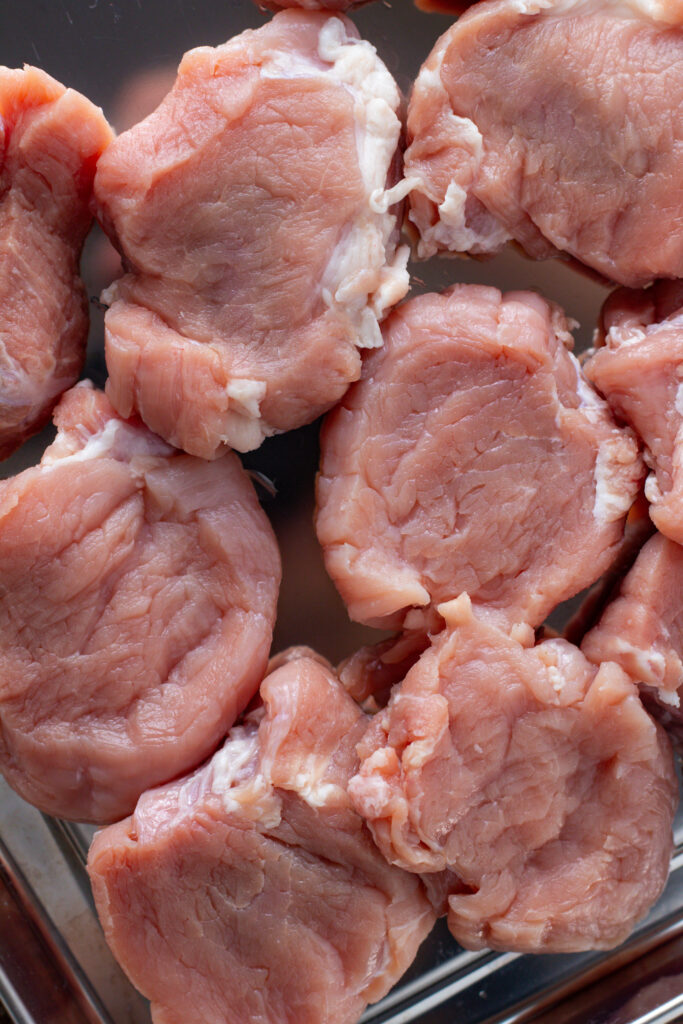 Uncooked pork medallions.