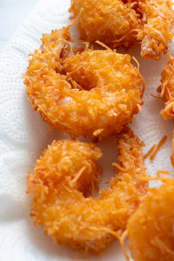 Freshly fried prawns or shrimp on a paper towel.