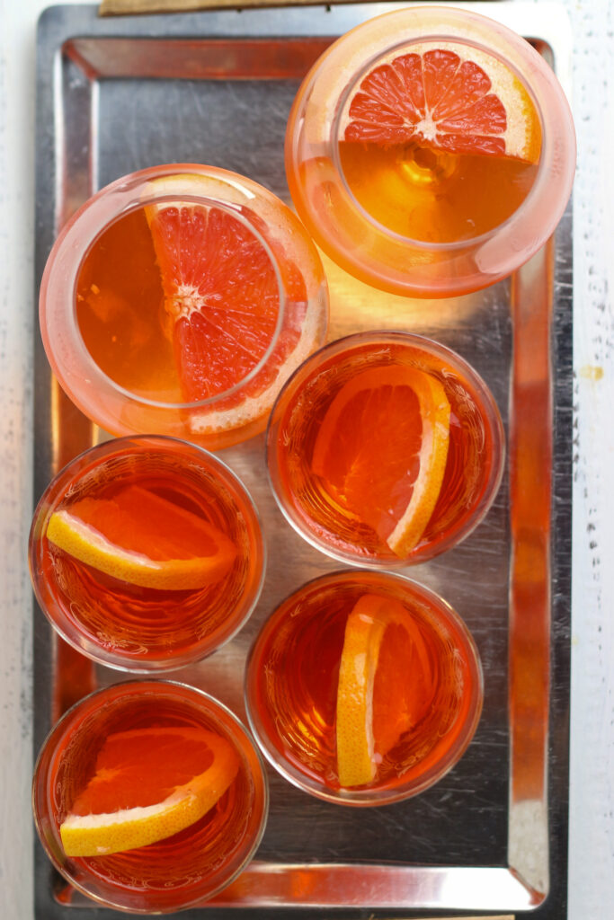 Aperol Spritz jellies in glasses with orange slice garnish seen from above.