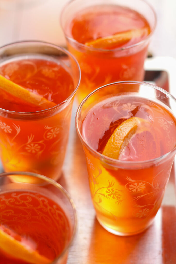 Aperol Spritz jellies in glasses with orange slice garnish.