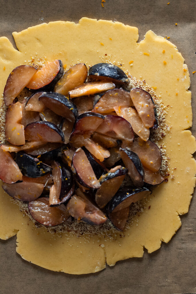 plums on pastry for plum galette.