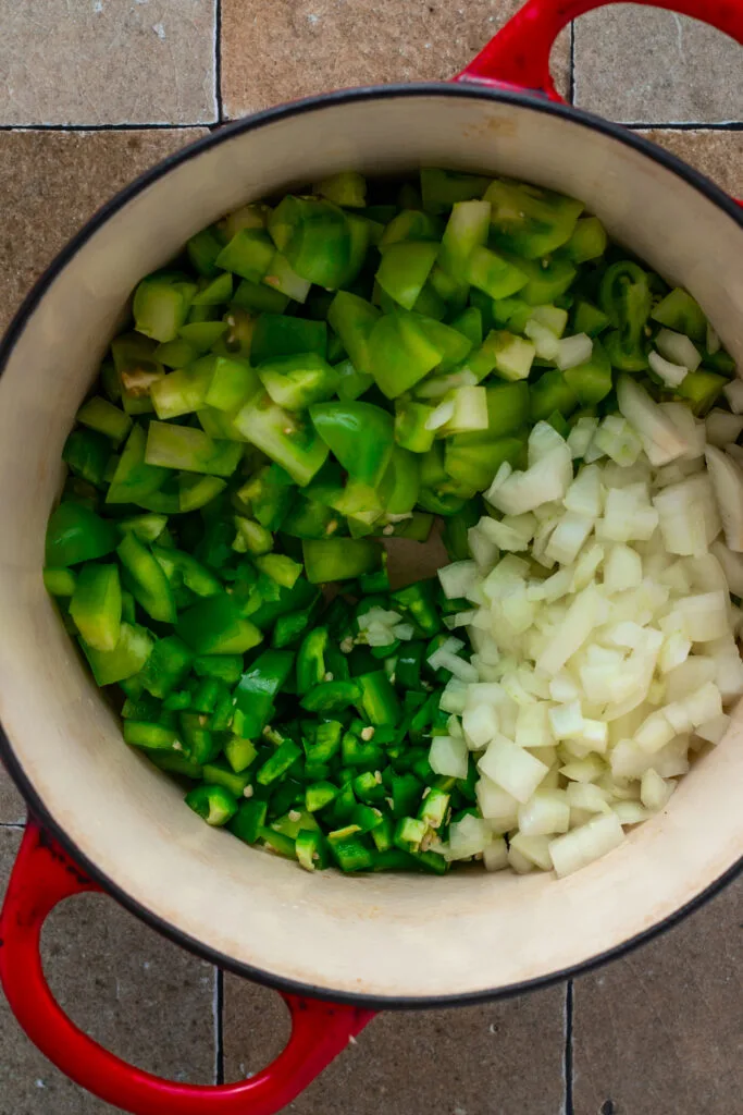 Ingredients for green tomato relish in a dutch oven.