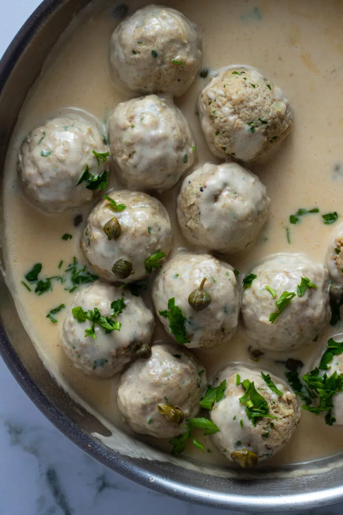 Königsberger Klopse: German meatballs in creamy caper sauce, served with potatoes and green beans.