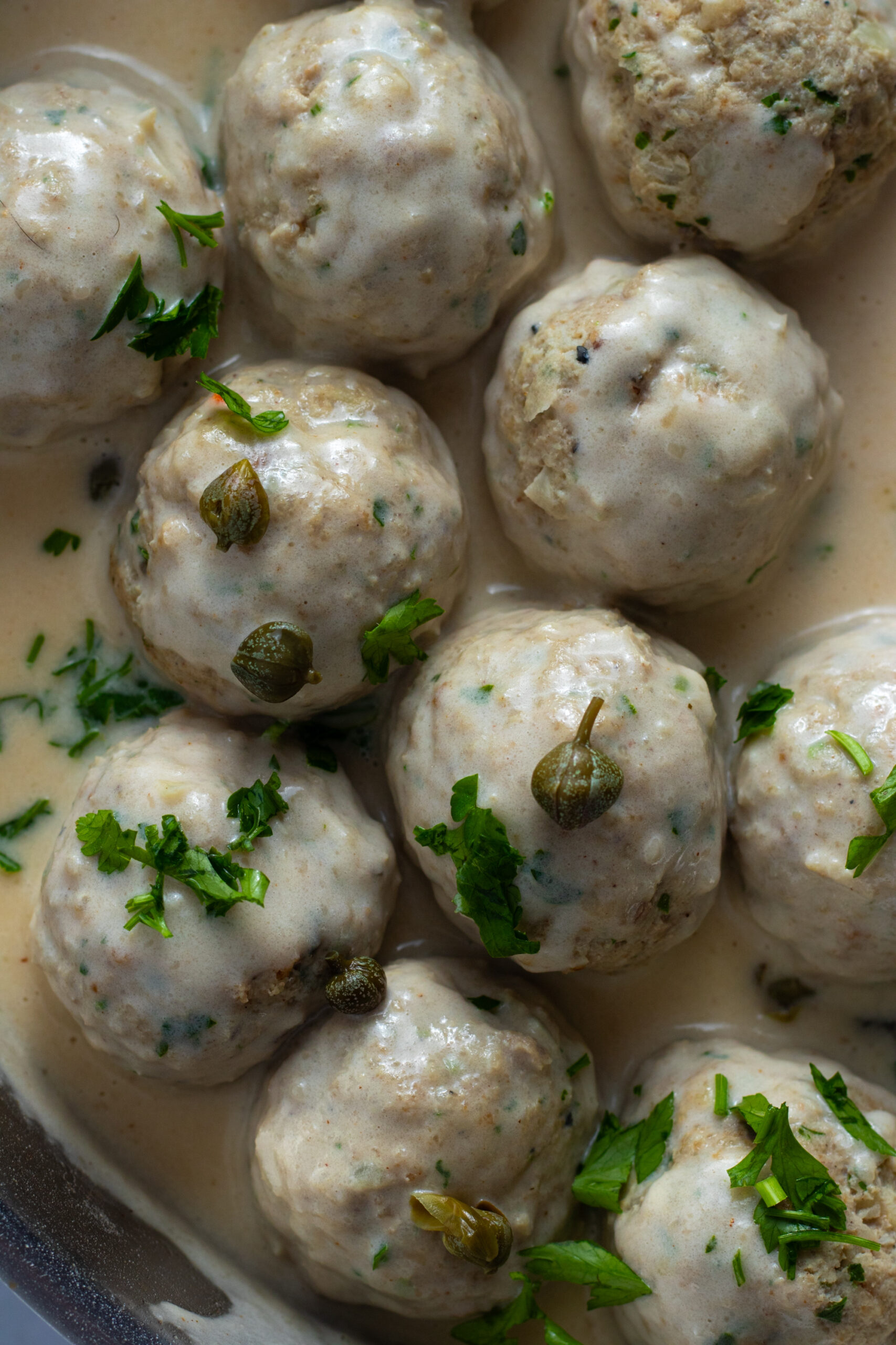 Königsberger Klopse: German meatballs in creamy caper sauce, garnished with parsley.