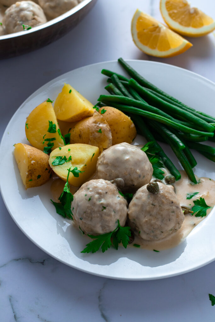 Königsberger Klopse: German meatballs with potatoes, green beans, and creamy caper sauce.