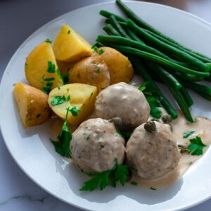 Königsberger Klopse: German meatballs in creamy caper sauce with potatoes and green beans.