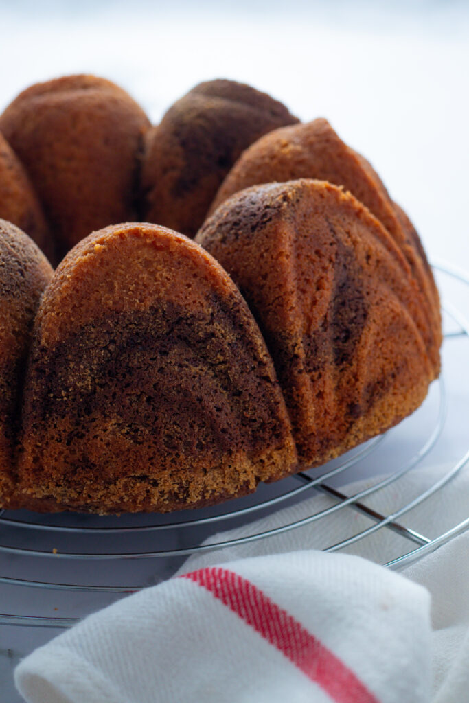 Marble cake cooling on a wire rack. Marmorkuchen, a German cake with a marbled pattern, is ready to serve.