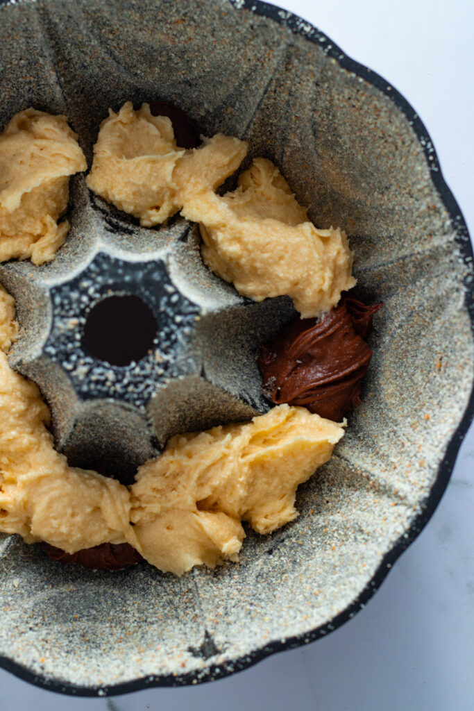 Marble cake batter in a Bundt pan, preparing a German Marmorkuchen.